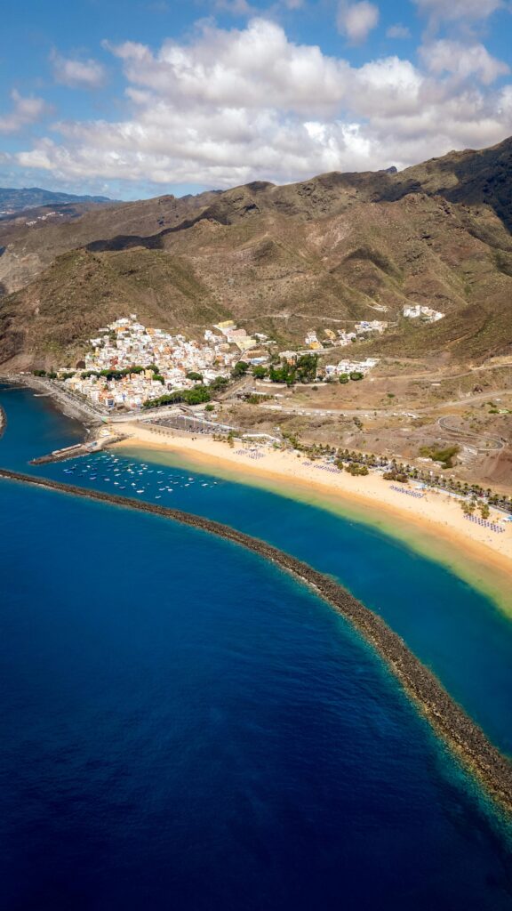 A breathtaking aerial shot of Tenerife's coastline, capturing pristine beaches and blue waters.